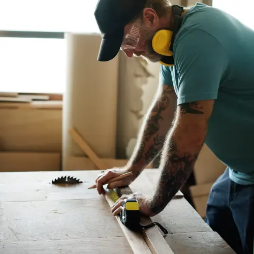 carpenter-using-pencil-measurement-tape-wood